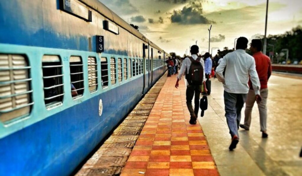 Travelers boarding an Indian Railways train during a day trip from Delhi.