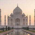 Taj Mahal at sunrise with soft morning light and calm atmosphere.