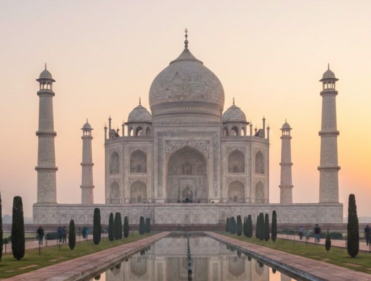 Taj Mahal at sunrise with soft morning light and calm atmosphere.