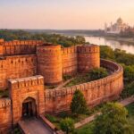 Aerial view of Agra Fort with the Taj Mahal visible across the Yamuna River in Agra, India