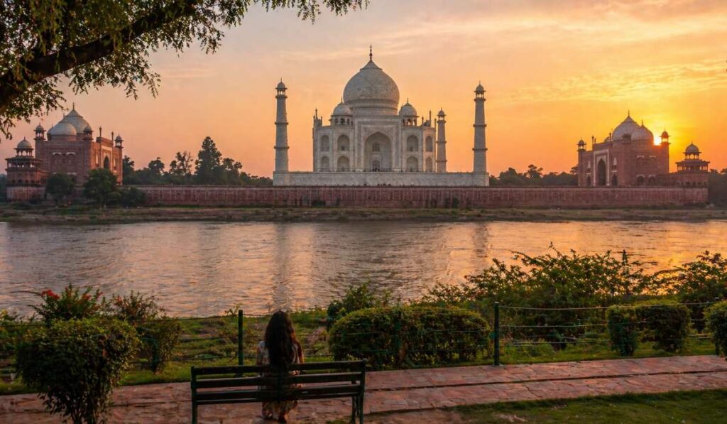 Taj Mahal sunset view from Mehtab Bagh across Yamuna River with peaceful surroundings in Agra India
