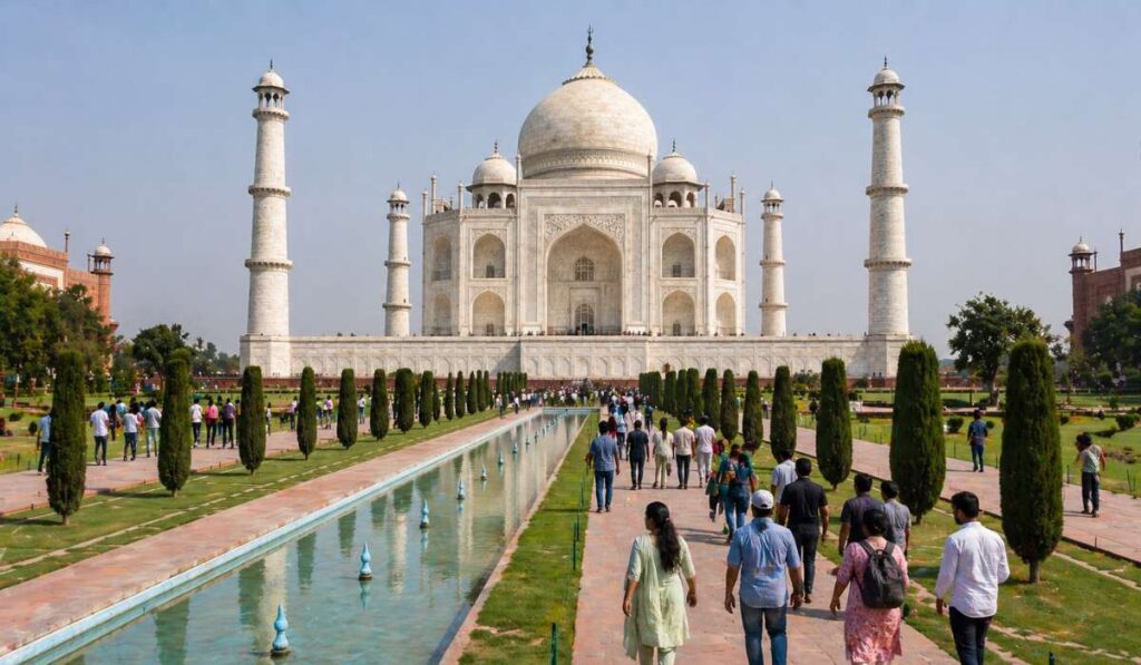 Moderate crowd at the Taj Mahal with tourists walking near the reflection pool in Agra India