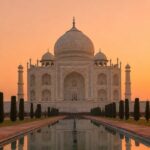 Taj Mahal at sunrise with golden light reflecting on the pool — Emperor Holidays sunrise tour from Delhi