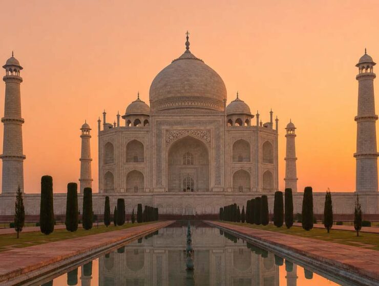 Taj Mahal at sunrise with golden light reflecting on the pool — Emperor Holidays sunrise tour from Delhi